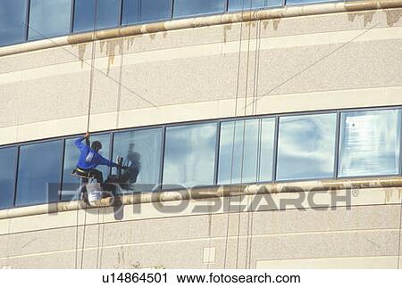 Stock Image - Window washer on a high rise building. Fotosearch
