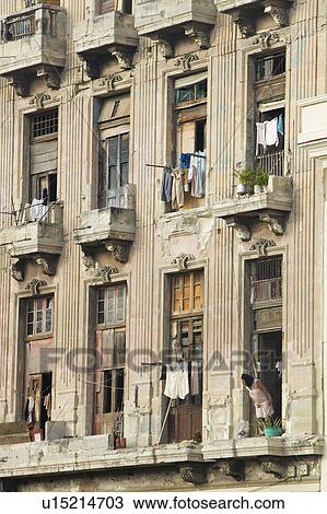 Stock Image - Woman looking out window at laundry. Fotosearch