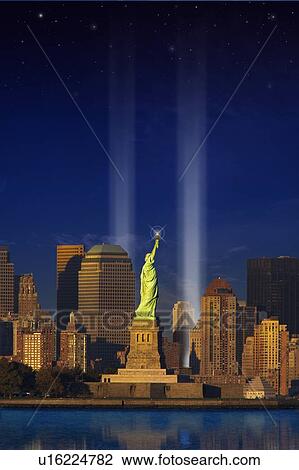 Stock Image - World Trade Center Light Memorial behind Statue of Liberty. Fotosearch