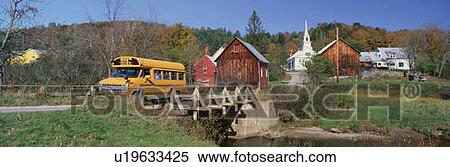 Stock Photography - Yellow school bus crossing wooden bridge. Fotosearch