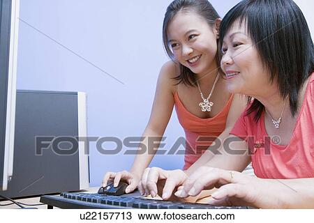 Side profile of a mature woman and her daughter using a computer View Large Photo Image Stock Image - Side profile of a mature woman and her daughter using a computer. Fotosearch