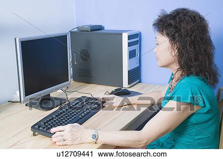 Side profile of a senior woman using a computer View Large Photo Image Stock Image - Side profile of a senior woman using a computer. Fotosearch