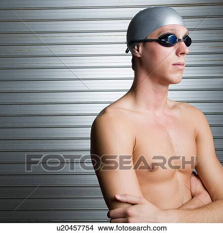 Close-up of a young man standing with his arms crossed View Large Photo Image Picture - Close-up of a young man standing with his arms crossed. Fotosearch