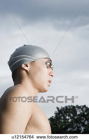 Close-up of a young man wearing swimming goggles View Large Photo Image Picture - Close-up of a young man wearing swimming goggles. Fotosearch