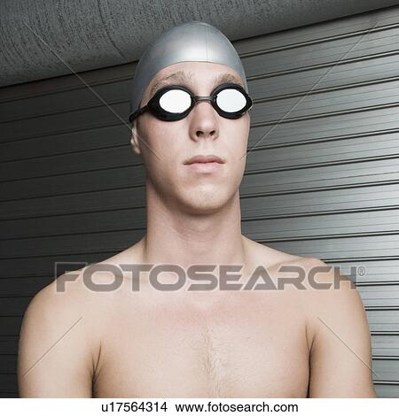 Close-up of a young man wearing swimming goggles View Large Photo Image Picture - Close-up of a young man wearing swimming goggles. Fotosearch
