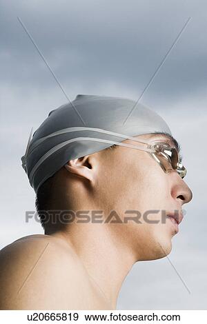 Close-up of a young man wearing swimming goggles View Large Photo Image Stock Photo - Close-up of a young man wearing swimming goggles. Fotosearch