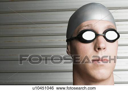 Close-up of a young man wearing swimming goggles View Large Photo Image Stock Photograph - Close-up of a young man wearing swimming goggles. Fotosearch