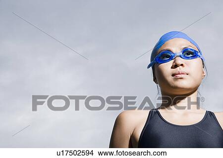 Close-up of a young woman wearing swimming goggles View Large Photo Image Picture - Close-up of a young woman wearing swimming goggles. Fotosearch
