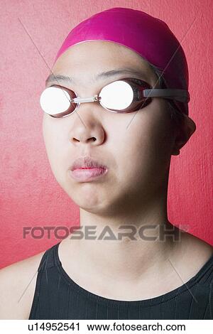 Close-up of a young woman wearing swimwear View Large Photo Image Stock Image - Close-up of a young woman wearing swimwear. Fotosearch