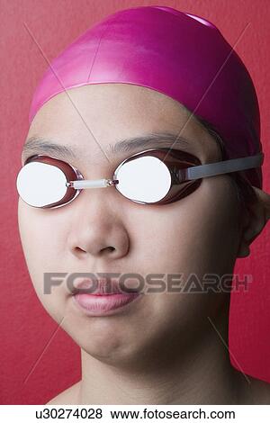 Close-up of a young woman wearing swimwear View Large Photo Image Stock Photo - Close-up of a young woman wearing swimwear. Fotosearch