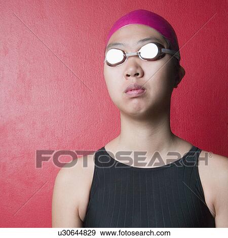 Close-up of a young woman wearing swimwear View Large Photo Image Stock Photo - Close-up of a young woman wearing swimwear. Fotosearch