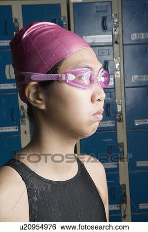 Close-up of a young woman wearing swimming goggles View Large Photo Image Stock Photograph - Close-up of a young woman wearing swimming goggles. Fotosearch