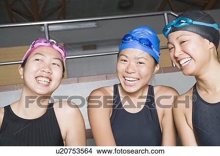 Close-up of three young women wearing swimwear and smiling View Large Photo Image Picture - Close-up of three young women wearing swimwear and smiling. Fotosearch