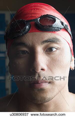 Portrait of a young man wearing swimming cap View Large Photo Image Stock Photo - Portrait of a young man wearing swimming cap. Fotosearch