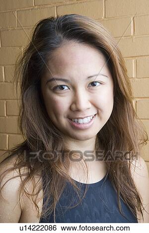 Portrait of a young woman smiling View Large Photo Image Stock Photograph - Portrait of a young woman smiling. Fotosearch