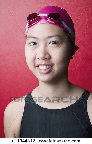 Portrait of a young woman wearing swimwear and smiling View Large Photo Image Stock Image - Portrait of a young woman wearing swimwear and smiling. Fotosearch