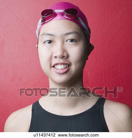 Stock Image - Portrait of a young woman wearing swimwear and smiling. Fotosearch