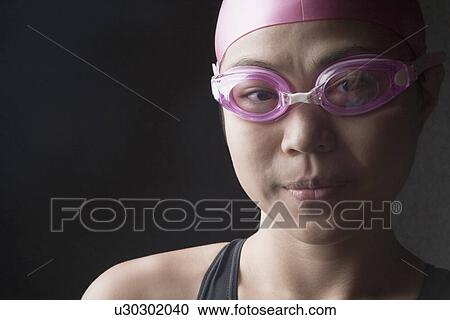 Portrait of a young woman wearing swimming goggles View Large Photo Image Stock Image - Portrait of a young woman wearing swimming goggles. Fotosearch