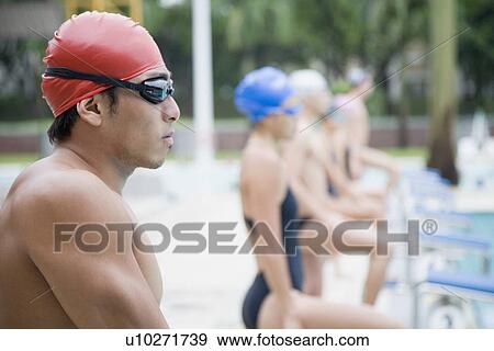 Side profile of a young man wearing swimming goggles and standing at a poolside View Large Photo Image Stock Photo - Side profile of a young man wearing swimming goggles and standing at a poolside. Fotosearch