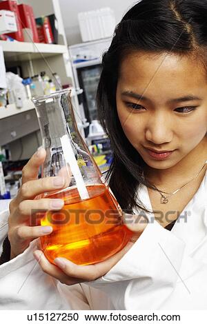 Close-up of a female pharmacist holding a conical flask in a laboratory View Large Photo Image Stock Image - Close-up of a female pharmacist holding a conical flask in a laboratory. Fotosearch