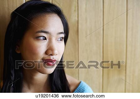 Close-up of a young woman grinning View Large Photo Image Stock Photograph - Close-up of a young woman grinning. Fotosearch