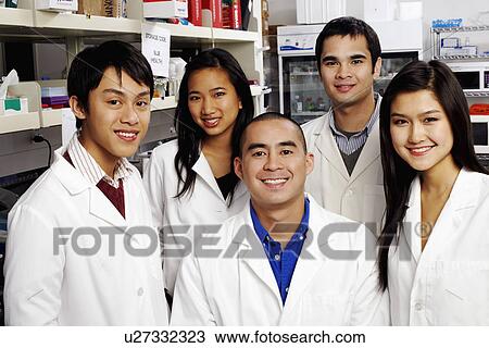 Stock Image - Portrait of a group of pharmacists in a laboratory. Fotosearch