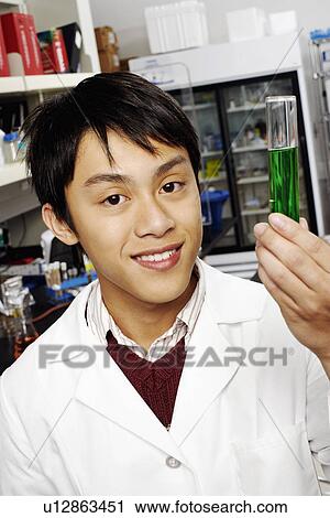 Portrait of a male pharmacist holding a test tube in a laboratory View Large Photo Image Stock Image - Portrait of a male pharmacist holding a test tube in a laboratory. Fotosearch