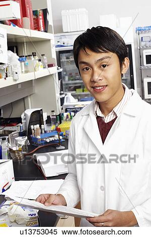 Portrait of a male pharmacist holding a document in a laboratory View Large Photo Image Stock Photography - Portrait of a male pharmacist holding a document in a laboratory. Fotosearch