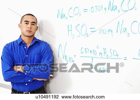 Stock Image - Portrait of a professor leaning against a whiteboard. Fotosearch