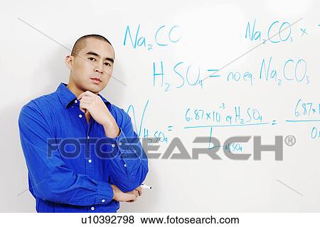 Portrait of a professor standing against a whiteboard View Large Photo Image Stock Photo - Portrait of a professor standing against a whiteboard. Fotosearch