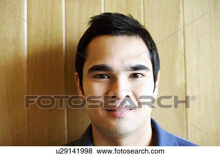 Portrait of a young man smirking View Large Photo Image Stock Photo - Portrait of a young man smirking. Fotosearch