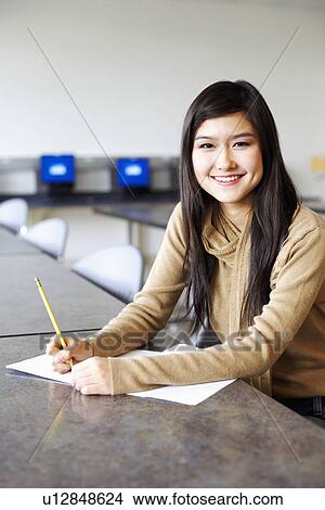 Portrait of a young woman sitting in an examination room View Large Photo Image Picture - Portrait of a young woman sitting in an examination room. Fotosearch