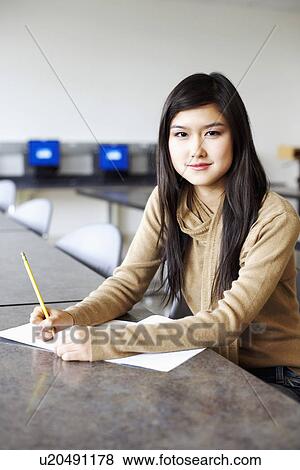 Portrait of a young woman sitting in an examination room View Large Photo Image Stock Photo - Portrait of a young woman sitting in an examination room. Fotosearch