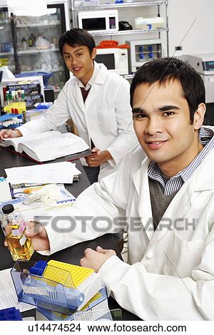 Side profile of two male pharmacists in a laboratory View Large Photo Image Picture - Side profile of two male pharmacists in a laboratory. Fotosearch