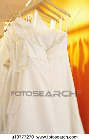 Wedding dresses hanging on a rack View Large Photo Image Stock Image - Wedding dresses hanging on a rack. Fotosearch