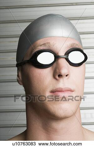 Close-up of a young man wearing swimming goggles View Large Photo Image Stock Image - Close-up of a young man wearing swimming goggles. Fotosearch