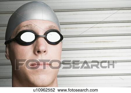 Close-up of a young man wearing swimming goggles View Large Photo Image Stock Image - Close-up of a young man wearing swimming goggles. Fotosearch