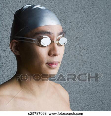 Close-up of a young man wearing swimming goggles View Large Photo Image Stock Image - Close-up of a young man wearing swimming goggles. Fotosearch