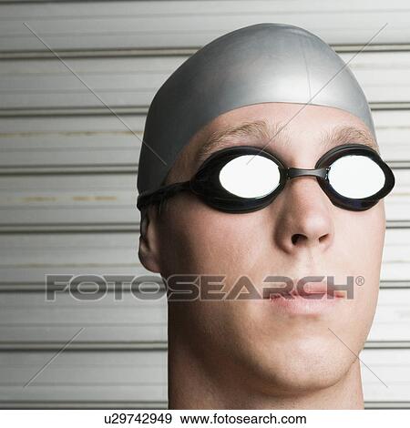 Stock Photo - Close-up of a young man wearing swimming goggles. Fotosearch