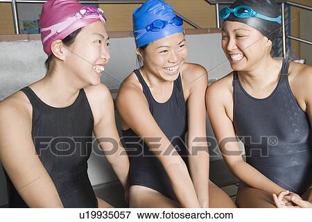 Close-up of three young women wearing swimwear and smiling View Large Photo Image Stock Photo - Close-up of three young women wearing swimwear and smiling. Fotosearch