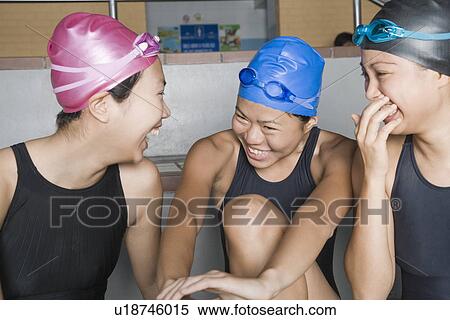 Stock Photography - Close-up of three young women wearing swimwear and smiling. Fotosearch