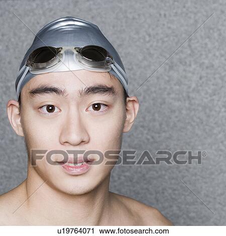 Portrait of a young man wearing a swimming cap View Large Photo Image Stock Image - Portrait of a young man wearing a swimming cap. Fotosearch