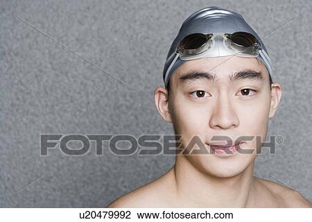 Portrait of a young man wearing a swimming cap View Large Photo Image Stock Image - Portrait of a young man wearing a swimming cap. Fotosearch