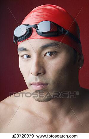 Portrait of a young man wearing a swimming cap View Large Photo Image Stock Photo - Portrait of a young man wearing a swimming cap. Fotosearch