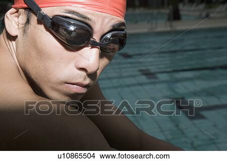 Portrait of a young man wearing swimming goggles View Large Photo Image Picture - Portrait of a young man wearing swimming goggles. Fotosearch
