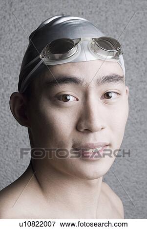 Portrait of a young man wearing swimming cap View Large Photo Image Stock Photo - Portrait of a young man wearing swimming cap. Fotosearch