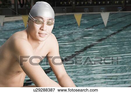 Portrait of a young man wearing swimming goggles View Large Photo Image Stock Photo - Portrait of a young man wearing swimming goggles. Fotosearch