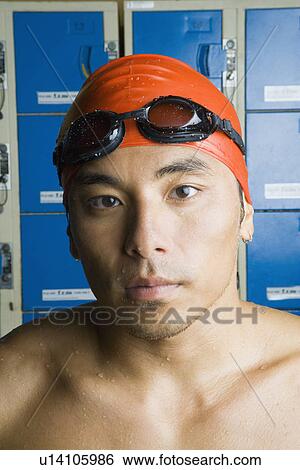 Portrait of a young man wearing swimming cap View Large Photo Image Stock Photograph - Portrait of a young man wearing swimming cap. Fotosearch