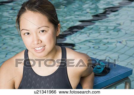 Portrait of a young woman wearing swimwear and smiling View Large Photo Image Stock Photograph - Portrait of a young woman wearing swimwear and smiling. Fotosearch