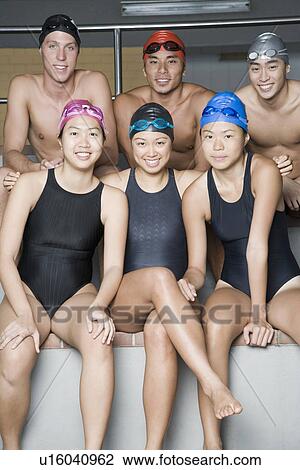 Stock Image - Portrait of three young men sitting with three young women. Fotosearch
